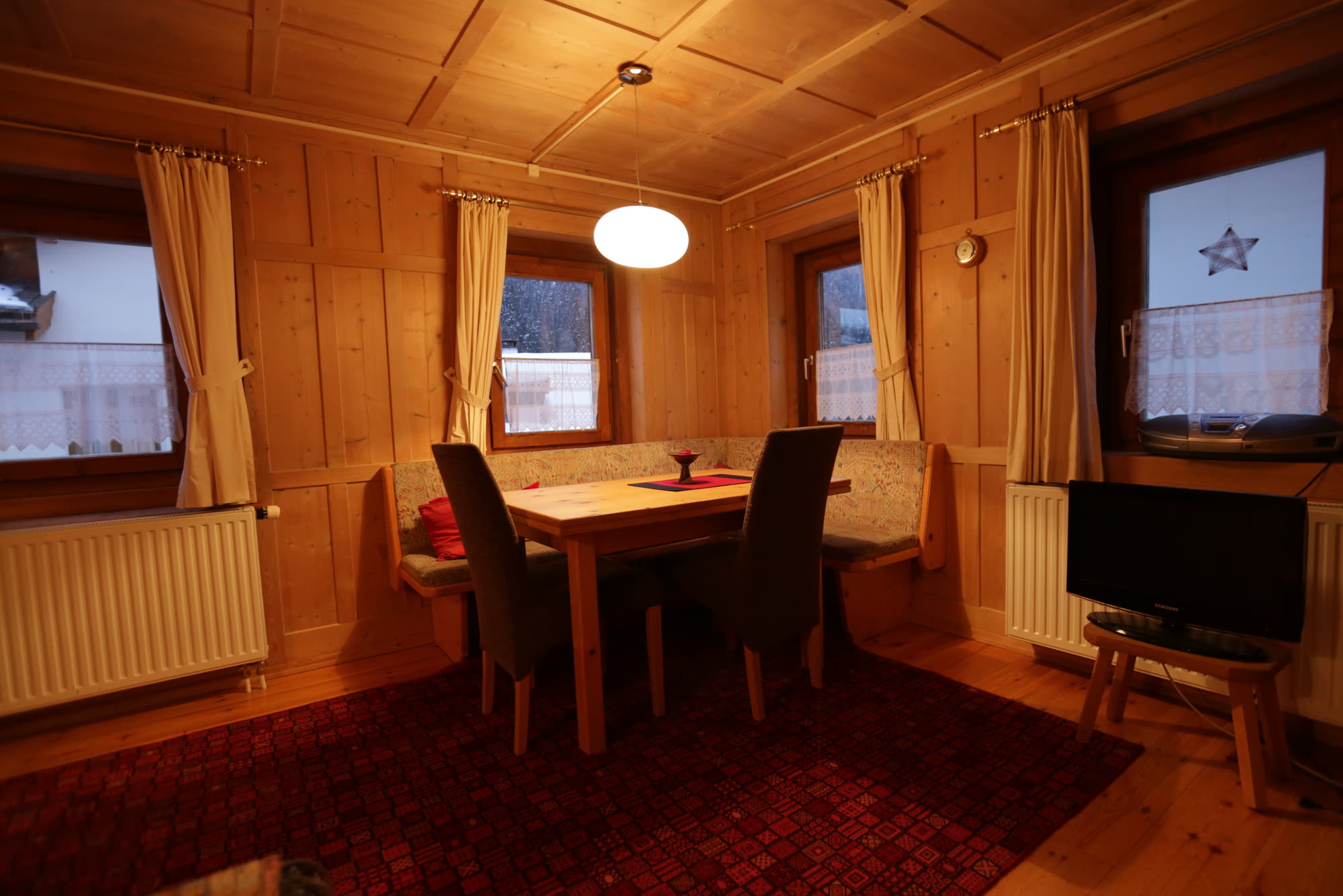 Stube mit Esstisch und Holztäfer